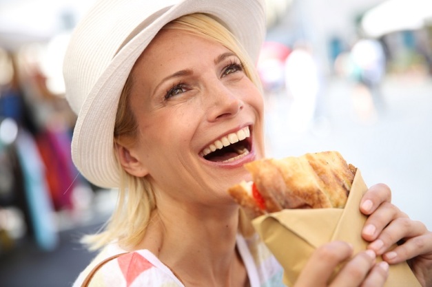 Woman in Rome relaxing and eating sandwich